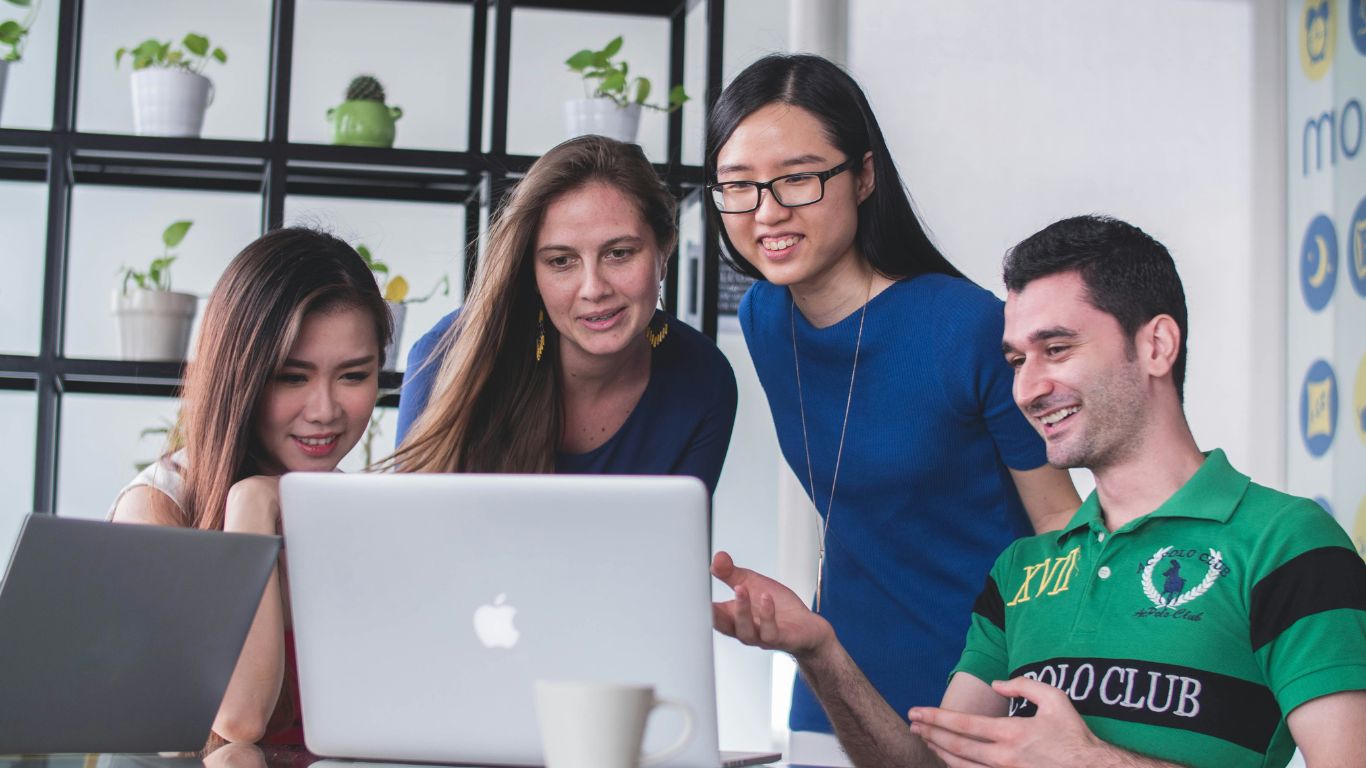 A creative team collaborating at a table, representing meet the team theweeklyspooncom.