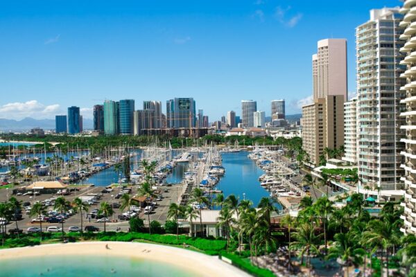 A scenic view of Florida beachfront hotels with ocean waves, palm trees