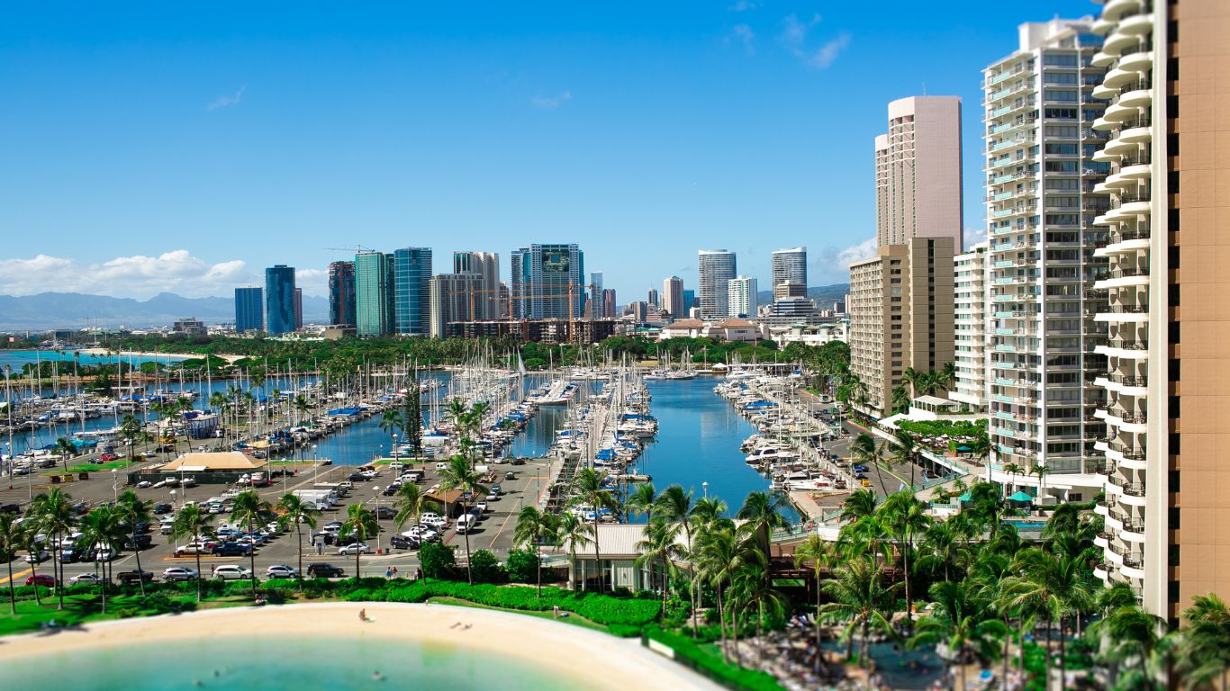 A scenic view of Florida beachfront hotels with ocean waves, palm trees